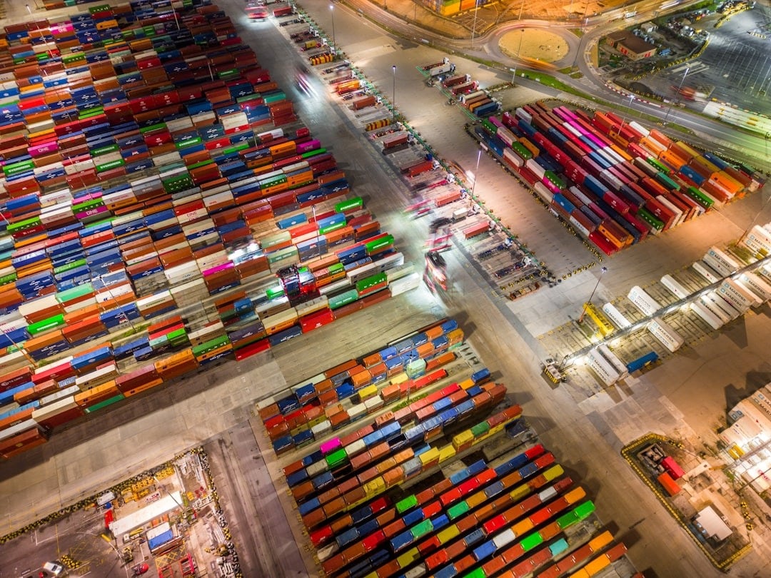 Thousands of colorful shipping containers stacked at a busy port.